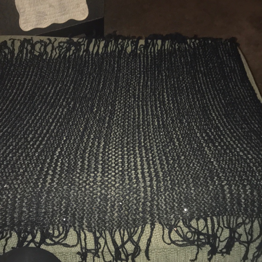 Black scarf with sequin accents. Fringed trim.